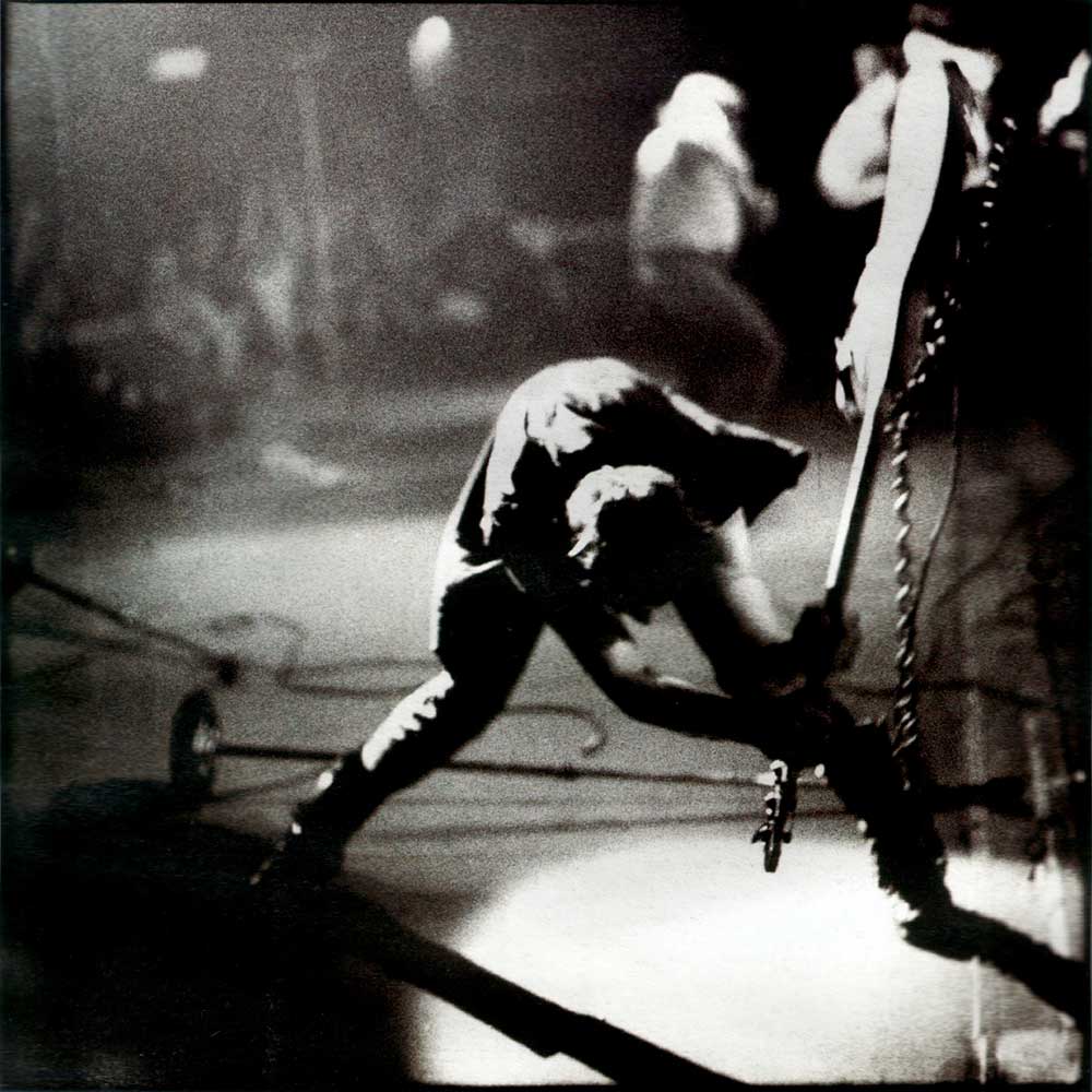 Paul Simonon of The Clash smashing his bass guitar